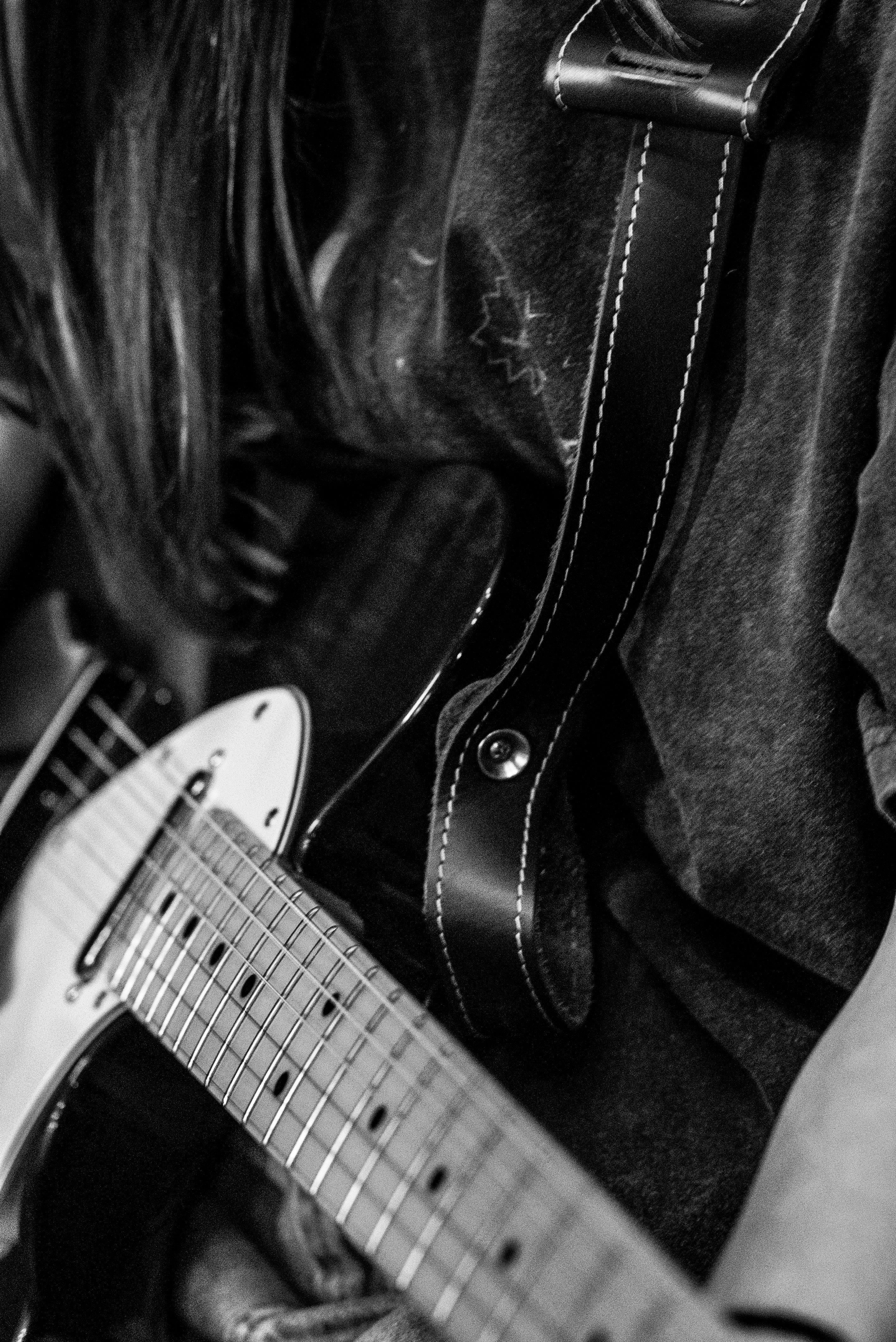 Model plays the guitar while wearing the "Popup" Graphic Tee in Navy